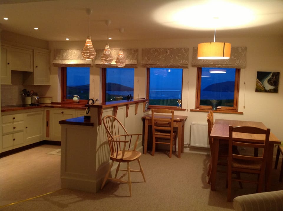 Kitchen and table with view out to sea