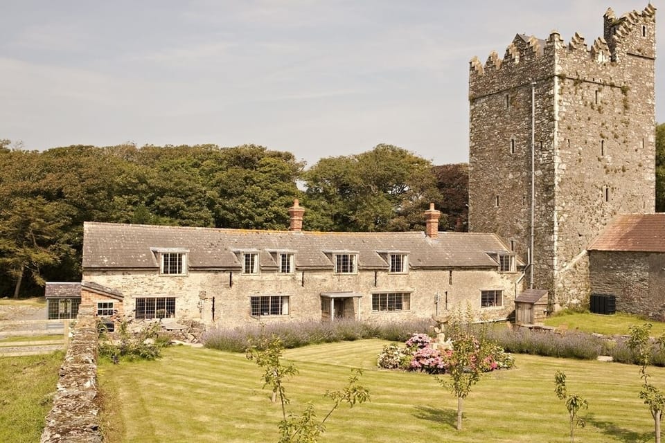Both cottages in the long building with Butlerstown Castle