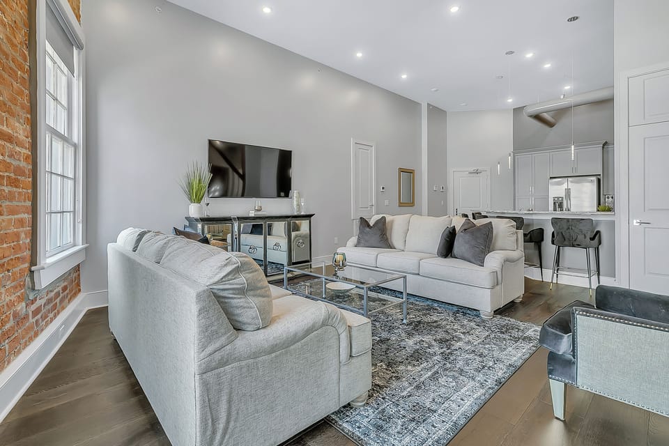 Open-concept living, kitchen, dining area with ample seating for you and your guests. 65” Samsung Smart 4K TV with streaming and DIRECTV Entertainment. The sofa converts to a queen-size sleeper! Dining table seats two. Enjoy plenty of natural light!