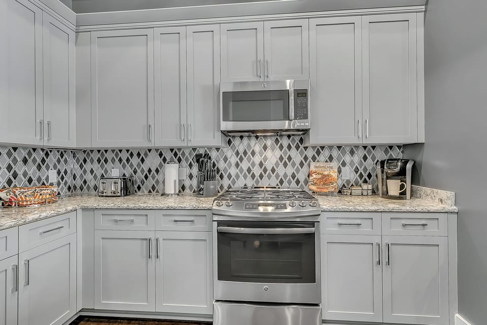 Cook and dine easily in the fully stocked kitchen, equipped with all stainless steel appliances, gas range, basic cookware, and a dining area for a comfortable meal at home. Entertain at the bar with seating for five.
