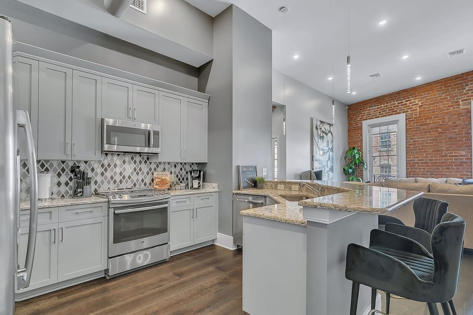 Cook and dine easily in the fully stocked kitchen, equipped with all stainless steel appliances, gas range, basic cookware, and a dining area for a comfortable meal at home. Entertain at the bar with seating for five.