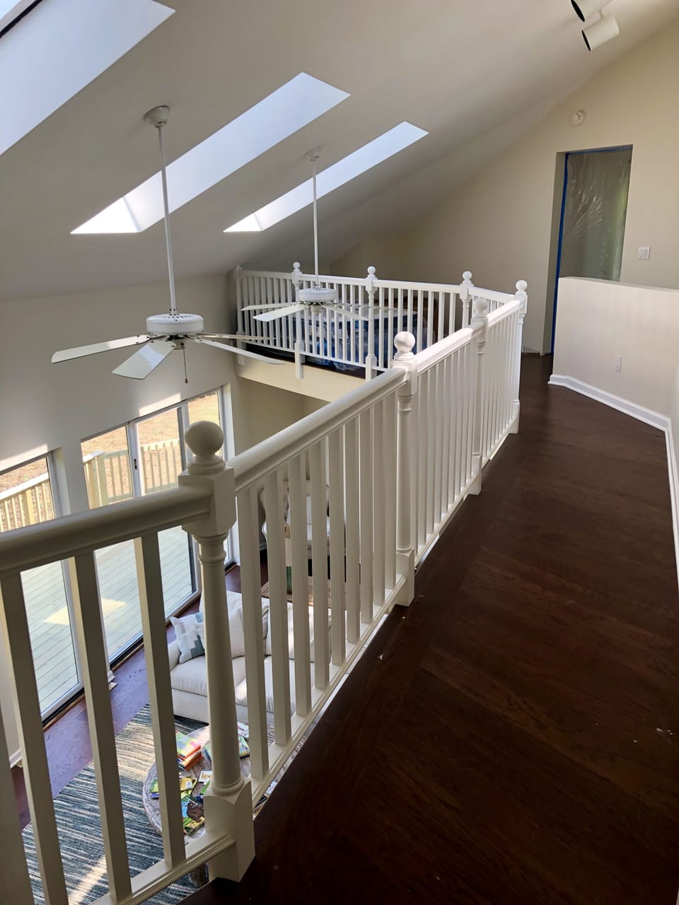 Upstairs walkway with skylights, overlooking the living room 