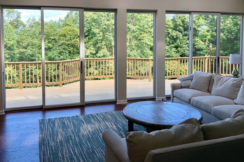 View of wraparound deck from living room -- sliding glass doors, view 
