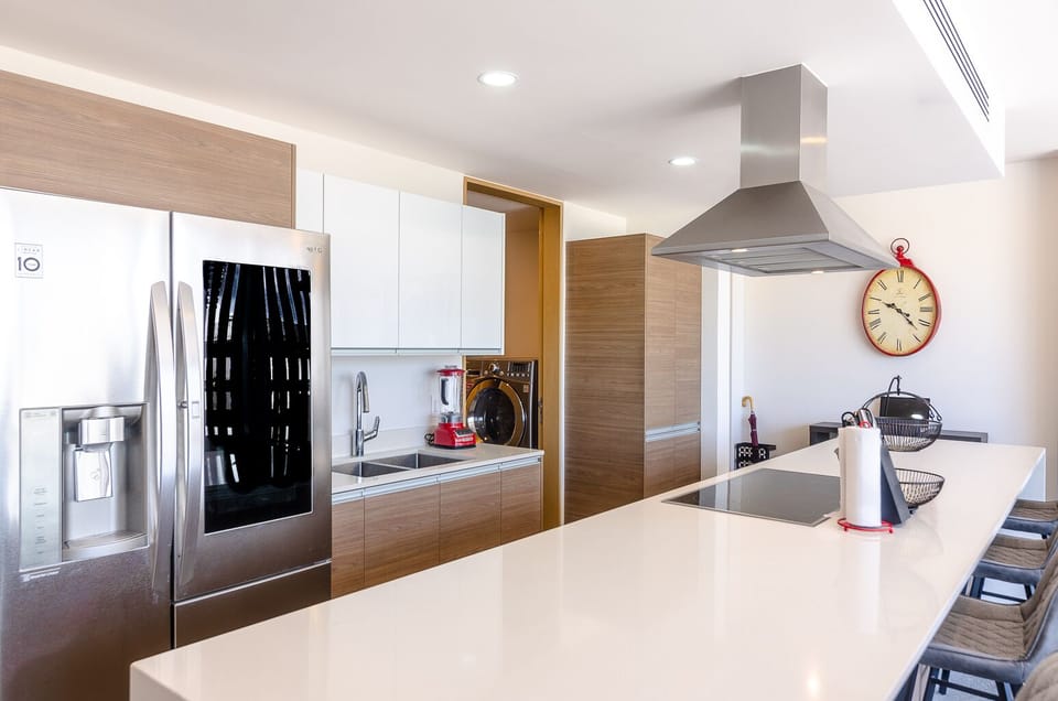 Luxury Chefs galley kitchen with LG flagship fridge and Kitchenaid appliances.