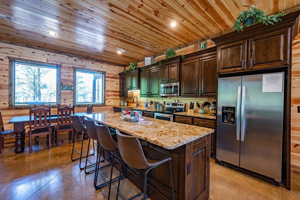 The fully stocked kitchen features granite countertops and stainless appliances.