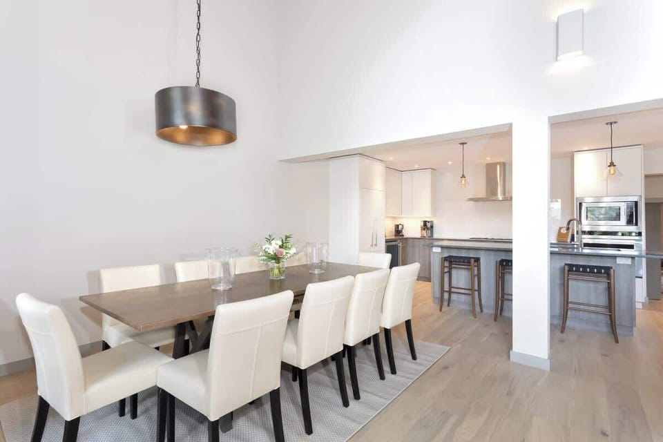 - Elegant dining area with seating for eight under chic pendant light  
- Seamless connection to modern kitchen for easy entertaining flow  
- Bright open layout ideal for family dinners and gatherings  
