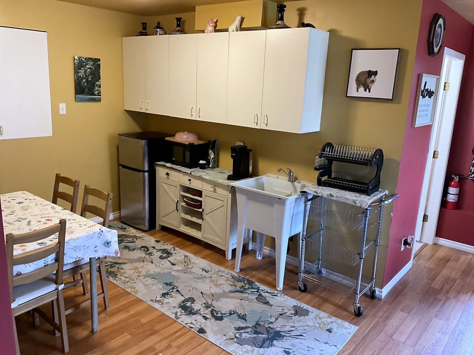 Well-equipped kitchenette with sink, mini-fridge, microwave and coffee station.