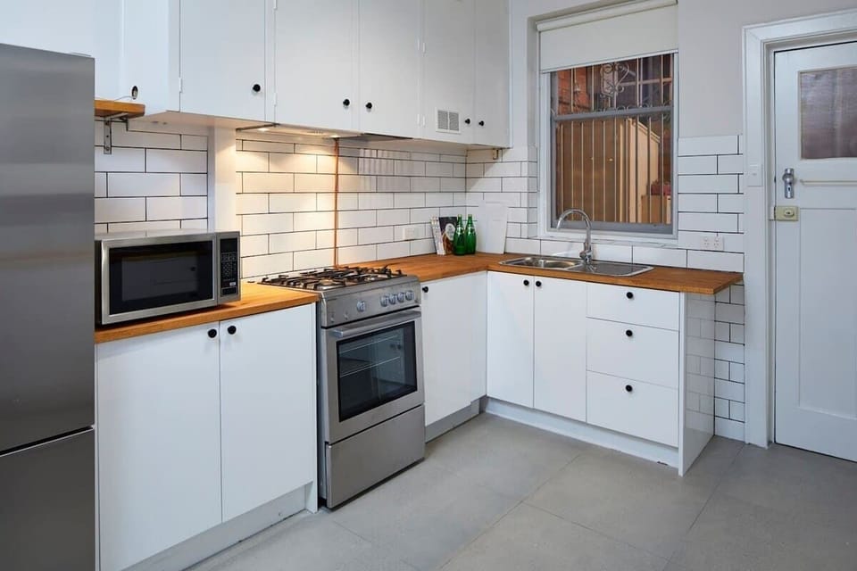Full size kitchen with gas cooktop and microwave oven