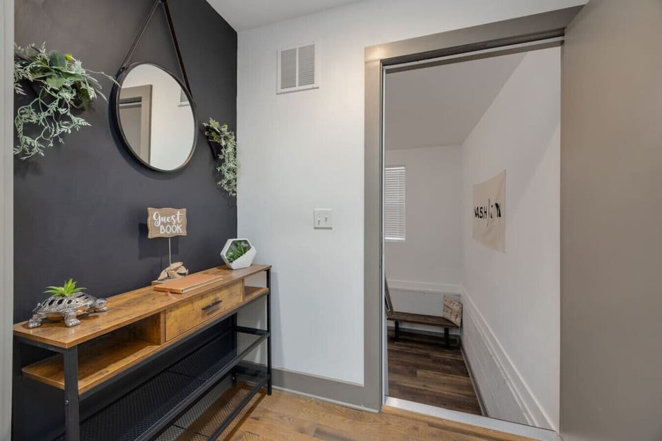 A bedroom with a bright window view and music-inspired art continues the Nashville vibe into the bedroom.