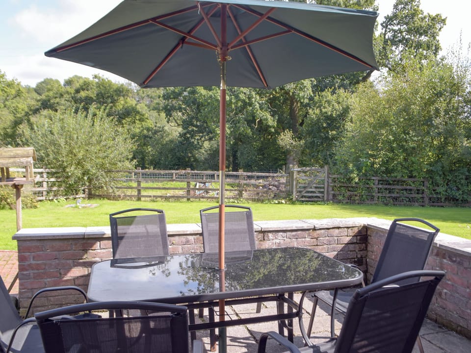 Paved patio area with outdoor furniture | Cothi Cottage - Upton Hall Cottages, Nantgaredig, near Llandeilo