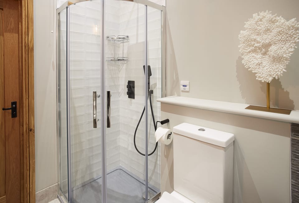 En-suite bathroom to bedroom one with bath and separate shower