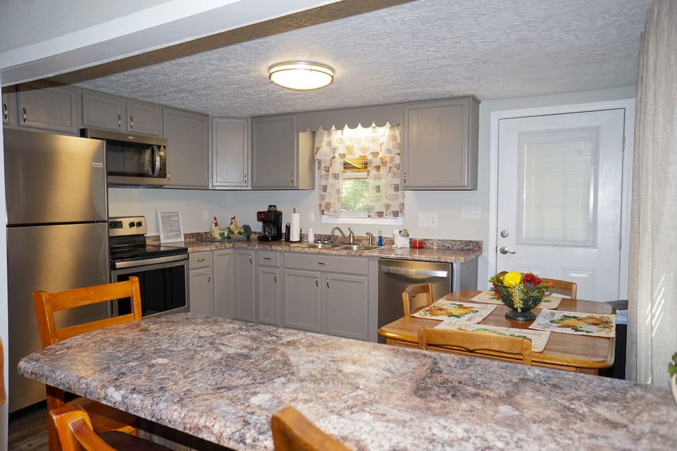 Kitchen - View of kitchen with dining table and bar for additional seating
