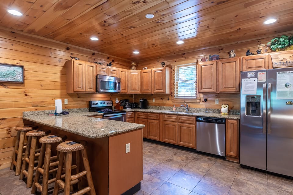 Large well-stocked kitchen with granite and stainless appliances