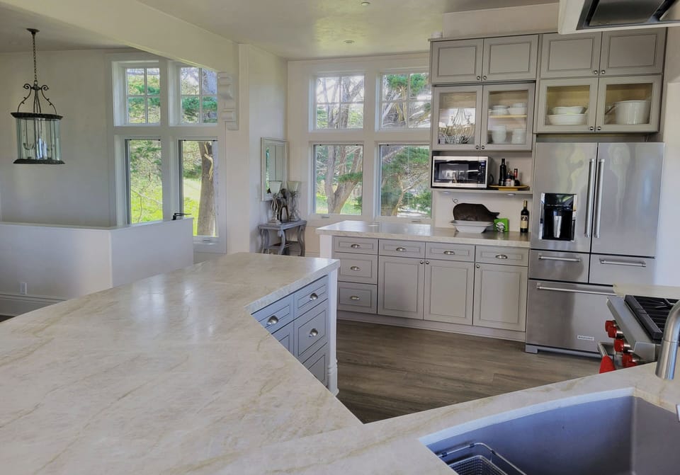 Kitchen Area from the Living Room. Morning sun floods through those windows.