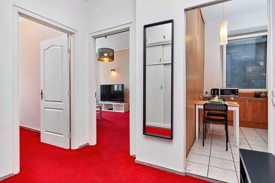 Stylish and elegant interior with red hues, white colors, and atmospheric wooden elements.