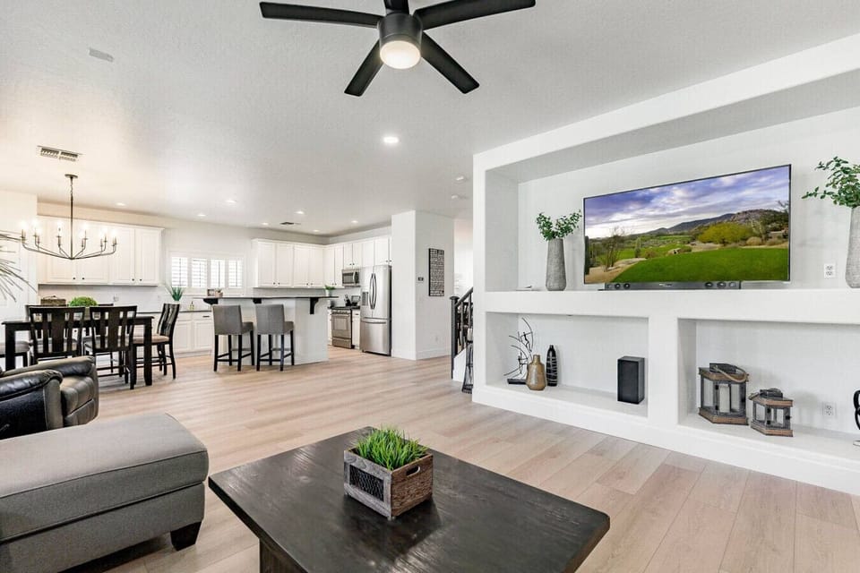 Bright open-concept living area featuring a modern TV wall, stylish furnishings, and seamless connection to the kitchen.