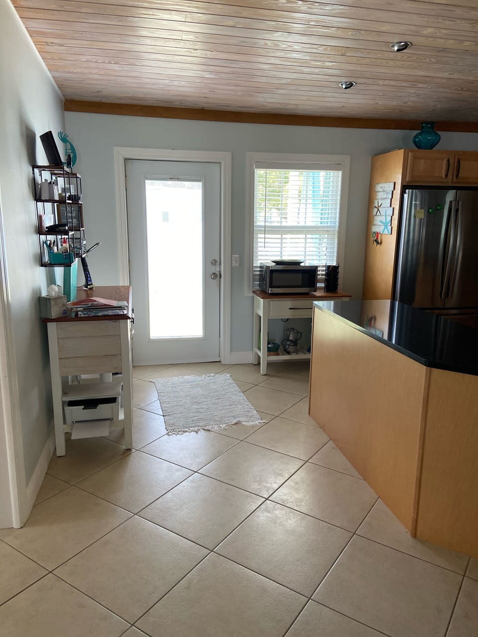 Desk and printer off of kitchen area