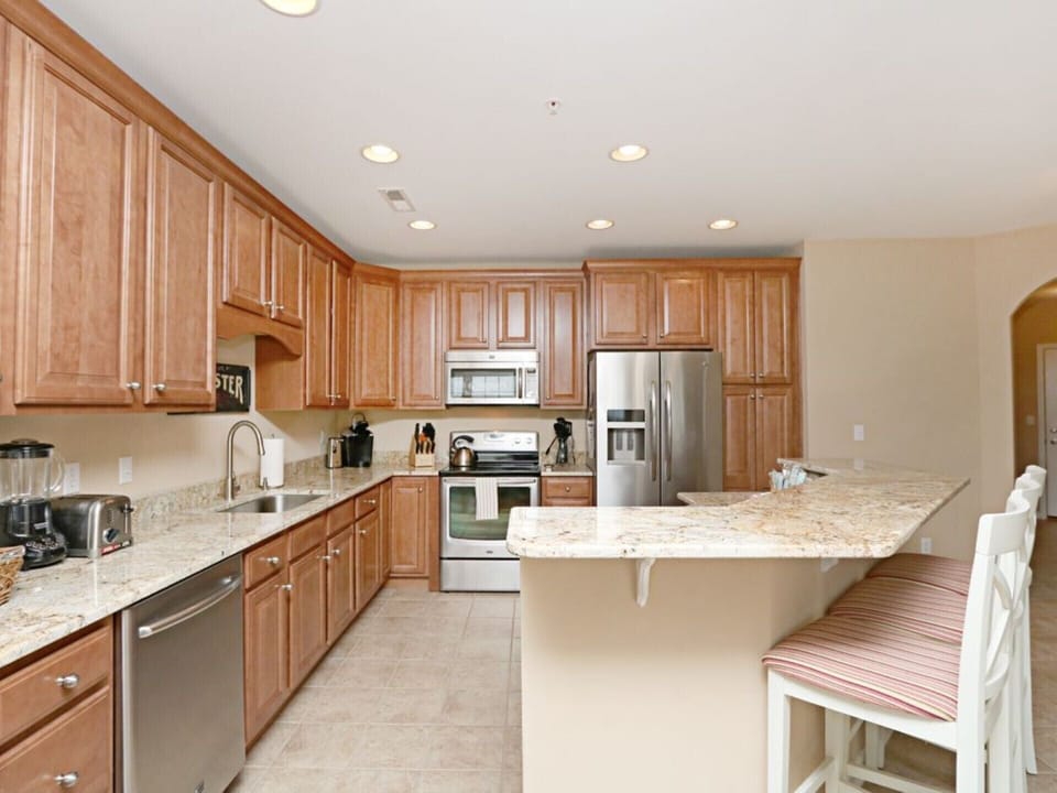 Large well stocked kitchen with new appliances and granite countertops