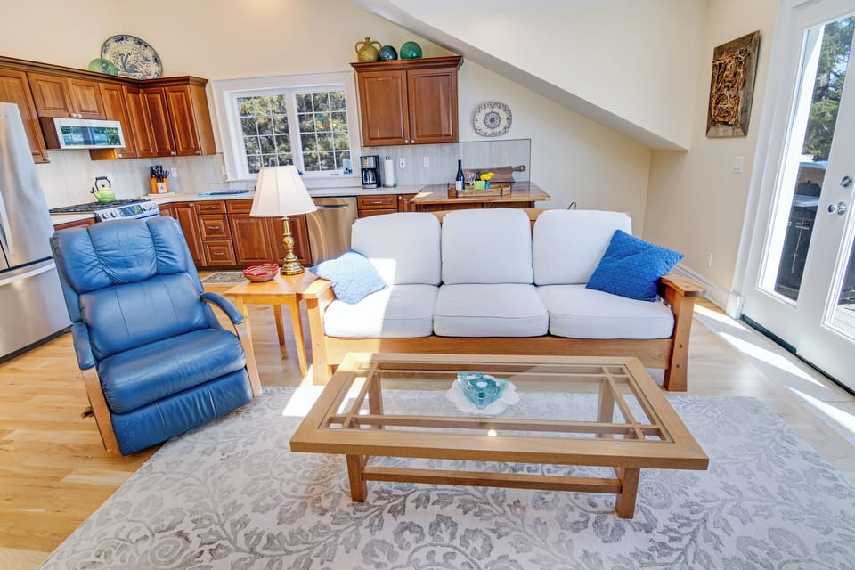 The living room welcomes you with a recliner and a Berkeley Mills sofa. 