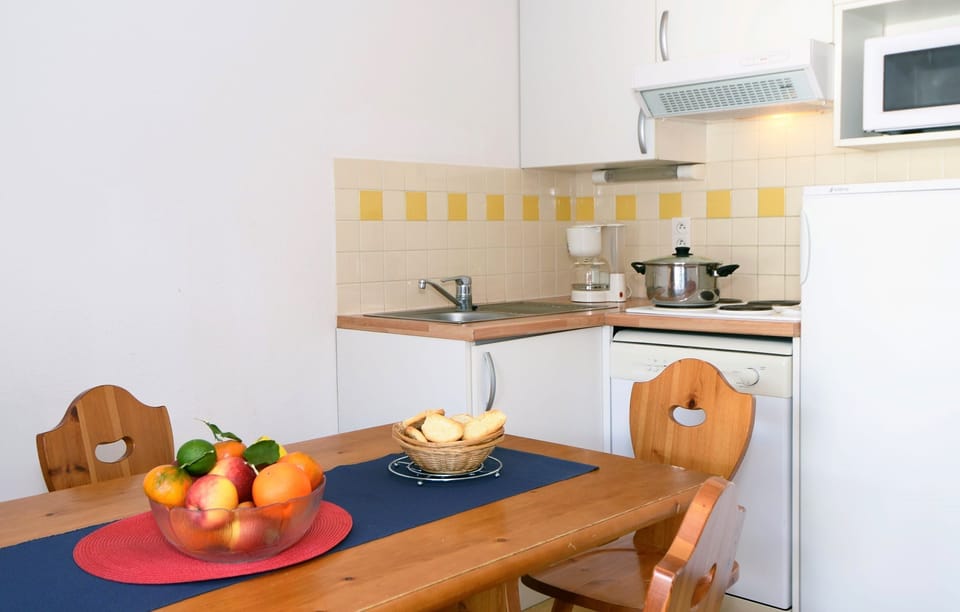 Prepare meals in the kitchenette and enjoy them at the dining table.