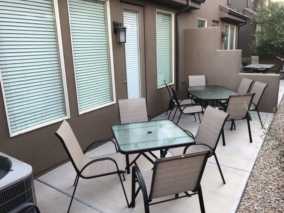 Outdoor patio has two tables that seats 10 and a large 6-burner gas grill.
