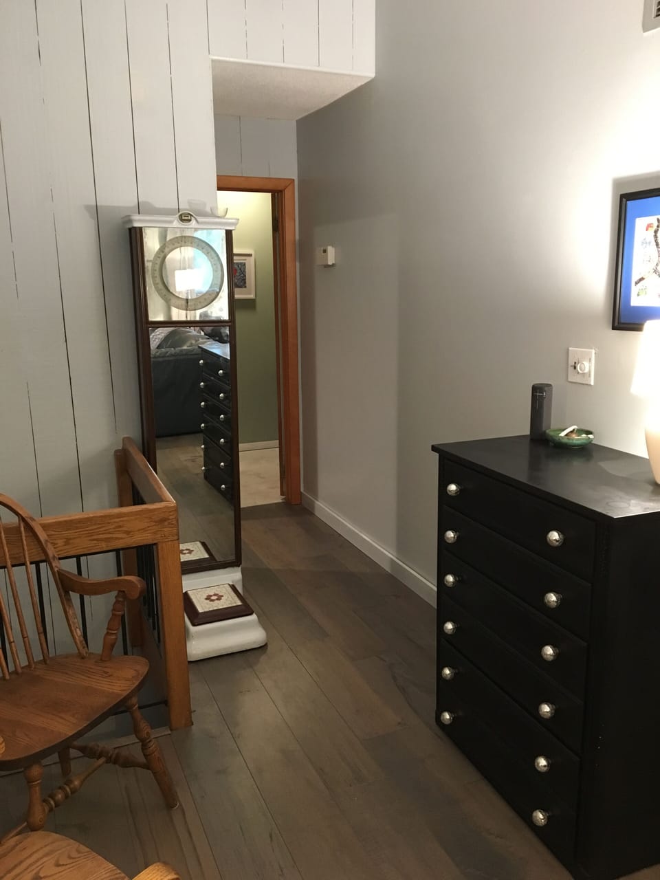 Main floor hallway to bath and upstairs BR.  Dresser and antique scale visible.