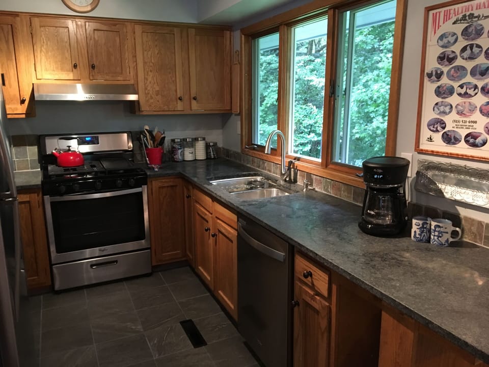 Newly redone kitchen with granite counters and stainless appliances.  
