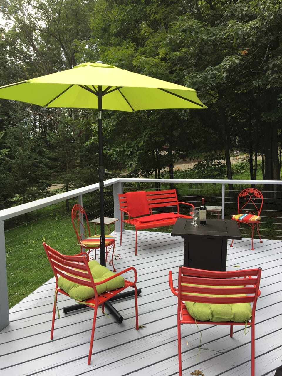Multiple seating areas on deck.  Firepit is here in the center.