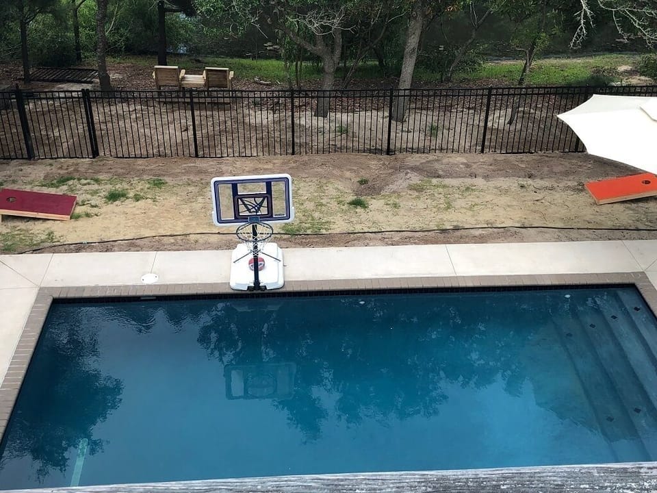 New concrete pool 2019. Fenced in backyard ready to play games like corn hole