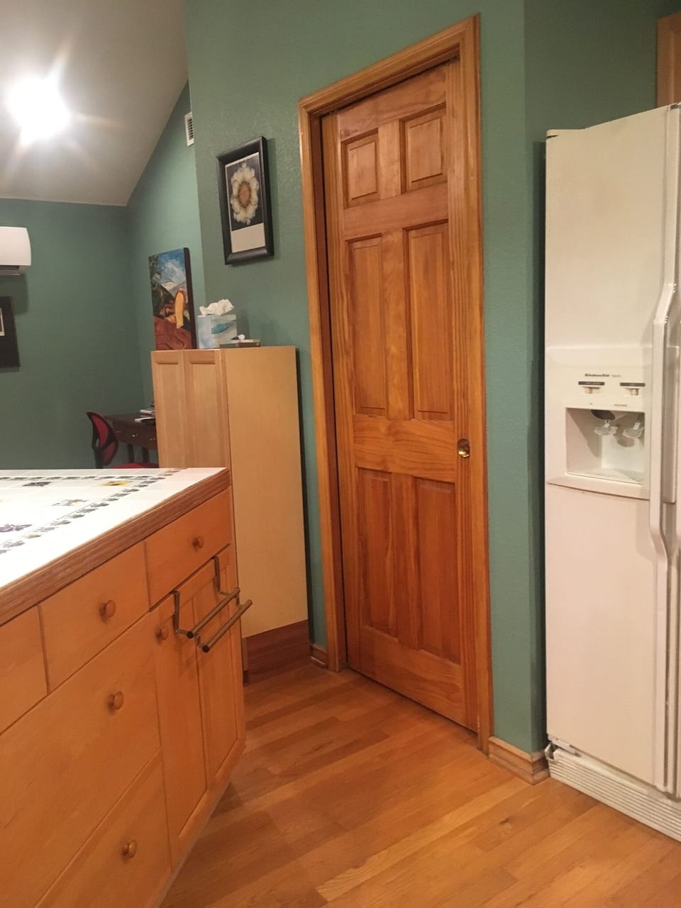 Door to pantry.  Pantry contains microwave and toaster oven, recycling and stuff