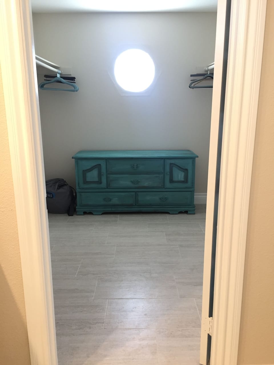 Master walk-in closet with dresser.