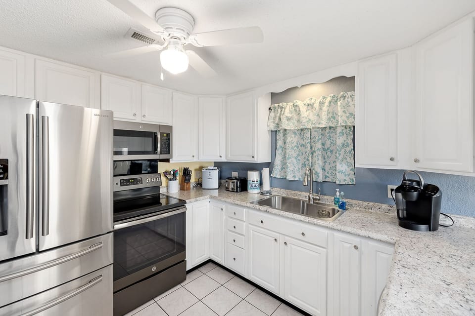 Featuring stainless appliances and a glass top stove with lots of counter space.