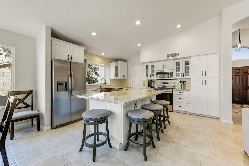 Kitchen adjacent the great room offers a large gathering area