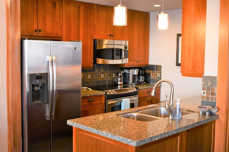 Fully Equipped Kitchen with stainless steel appliances and dishwasher.