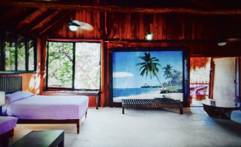 The studio features a double bed plus 2 twin beds in the same space