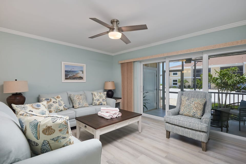 Fully equipped kitchen, expansive living room with comfy furniture, and walk out ground level patio