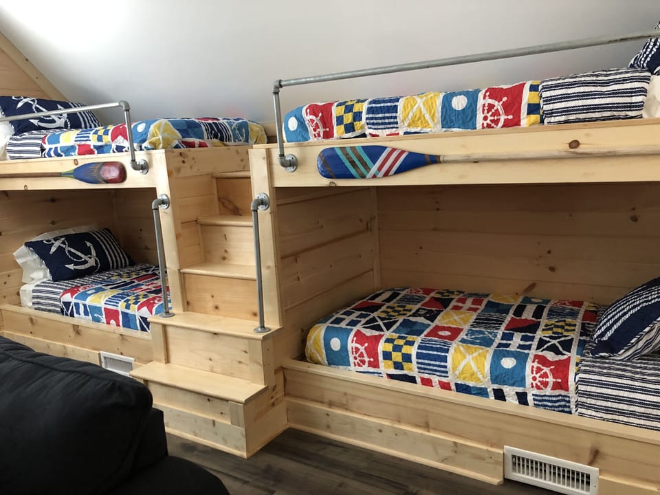 Loft upstairs bunkroom— 4 twin beds and couch with tv, board games & video game.