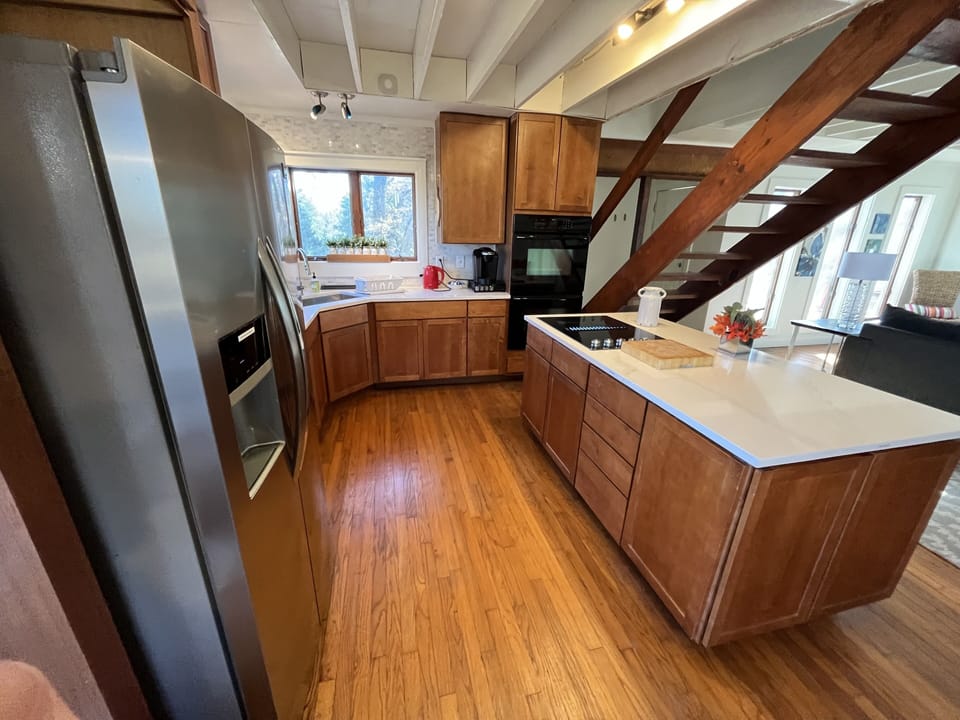 Kitchen is equipped with ovens, K-cup and drip coffee, kettle, condiments