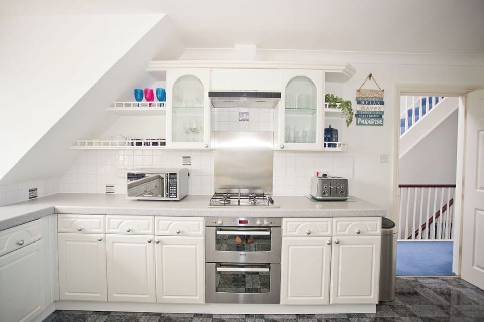 Electric double oven with four burner gas hob above