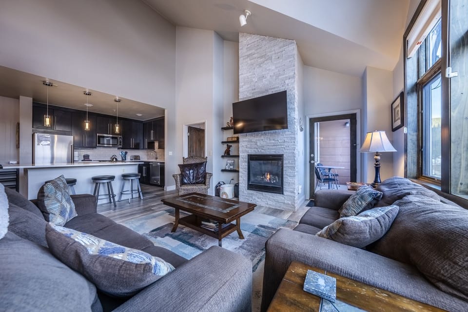 Living room - This living room boasts high ceilings, amazing views, access to a private balcony, and is seamlessly integrated into an open floor plan.