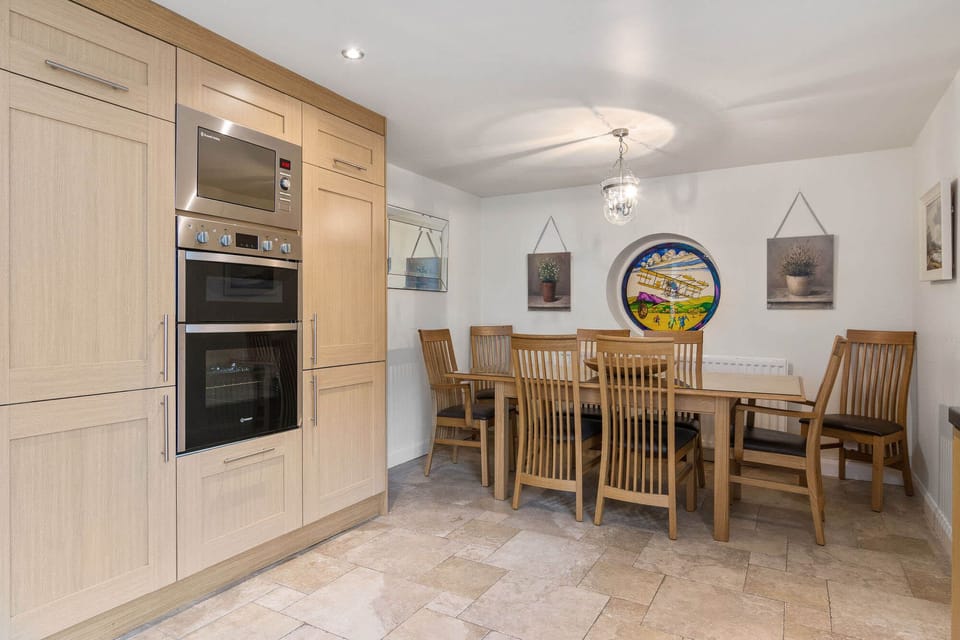 Large kitchen with generous and comfortable dining area. Direct access to patio.