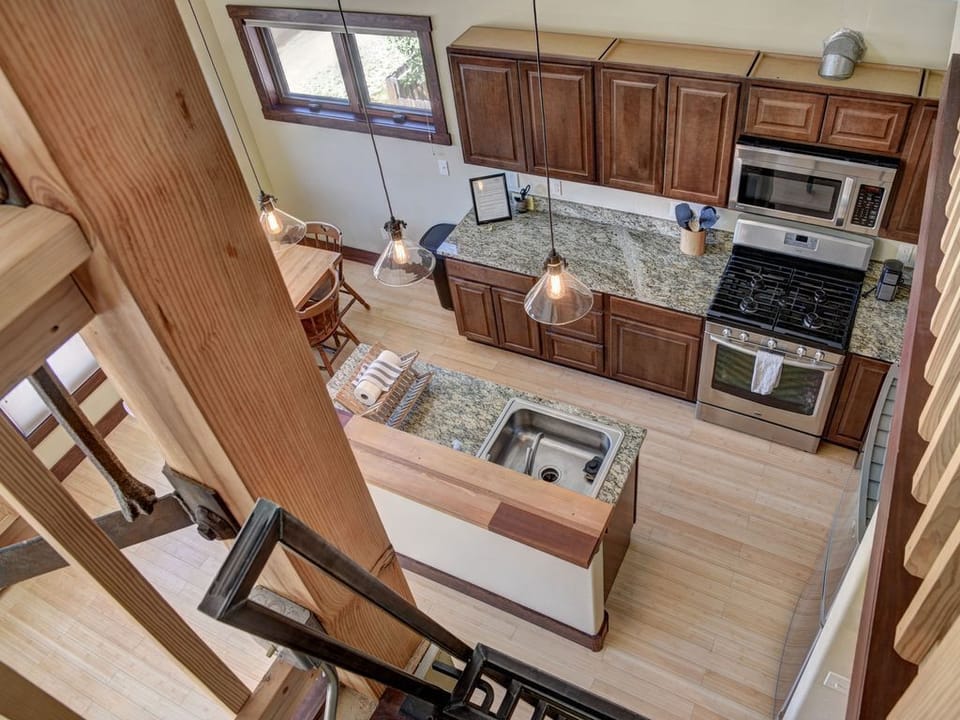 Looking down to kitchen from loft
