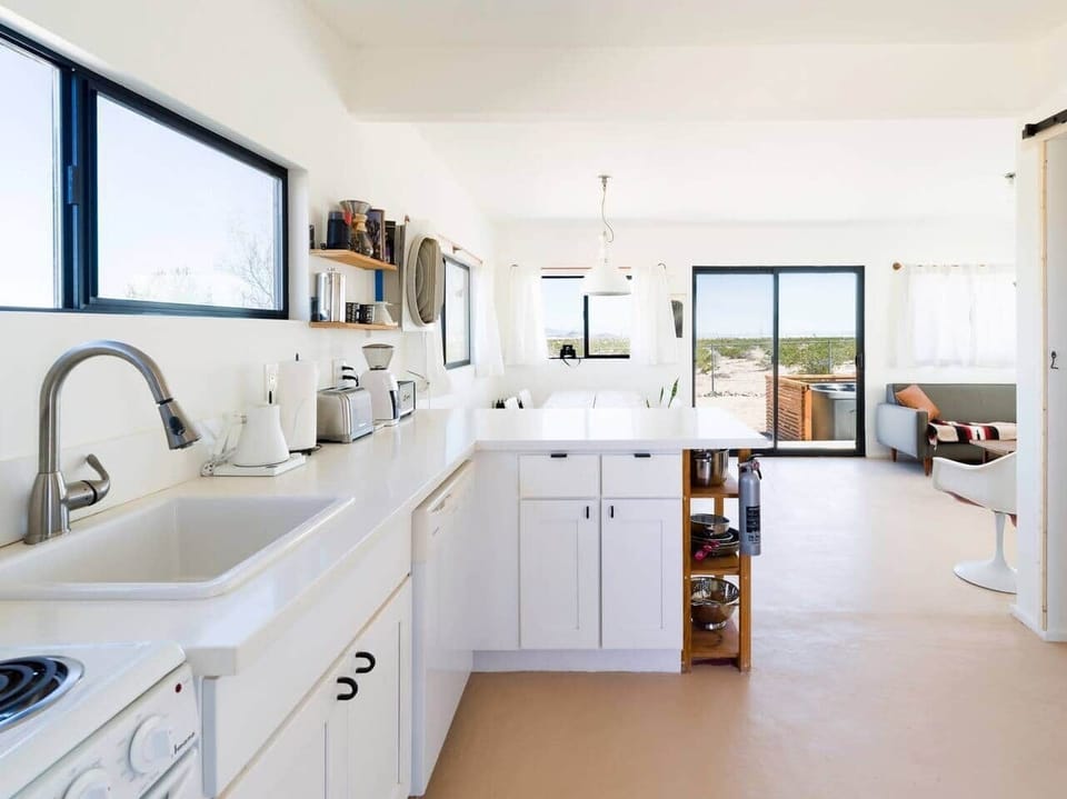 View of the kitchen, dining room and living space. Hot tub is just out on the porch for easy access on cold nights.