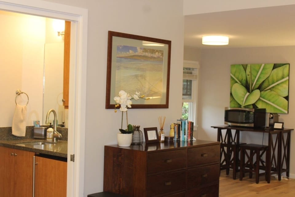 small refrigerator and ice maker under the kitchen bar for groceries and drinks