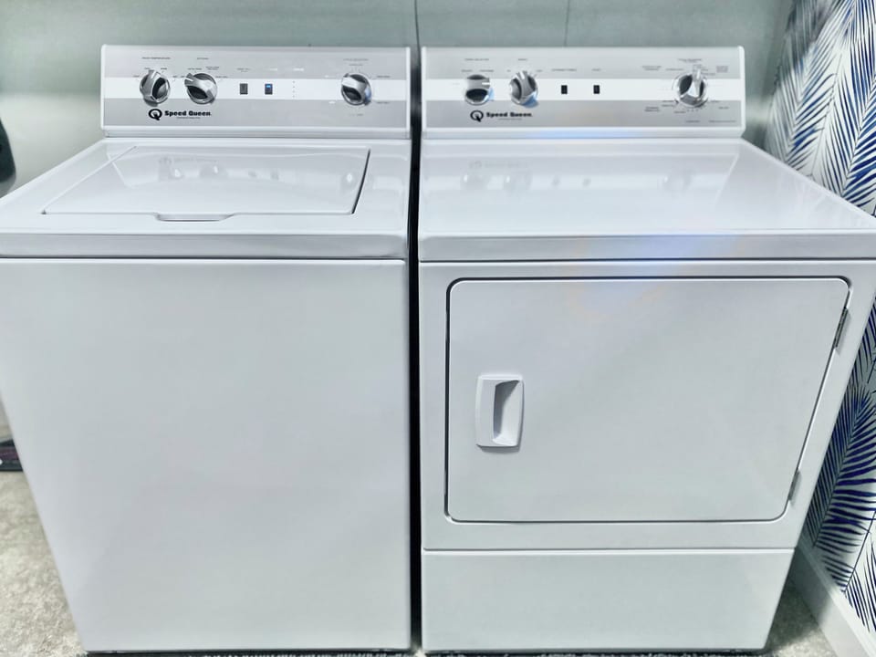 A washer and dryer are available in a large laundry room with a folding table.