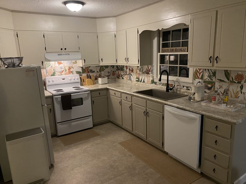 Touch-free faucet, microwave, toaster, refrigerator/freezer, and a dishwasher.