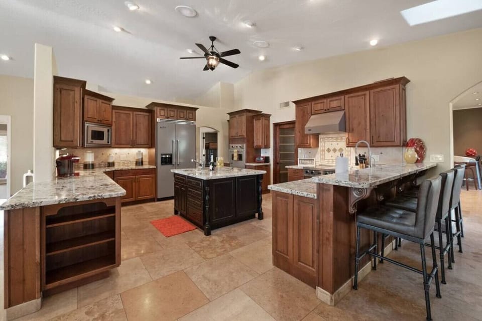 Your spacious gourmet kitchen awaits with granite countertops, premium appliances, and a breakfast bar perfect for morning coffee.