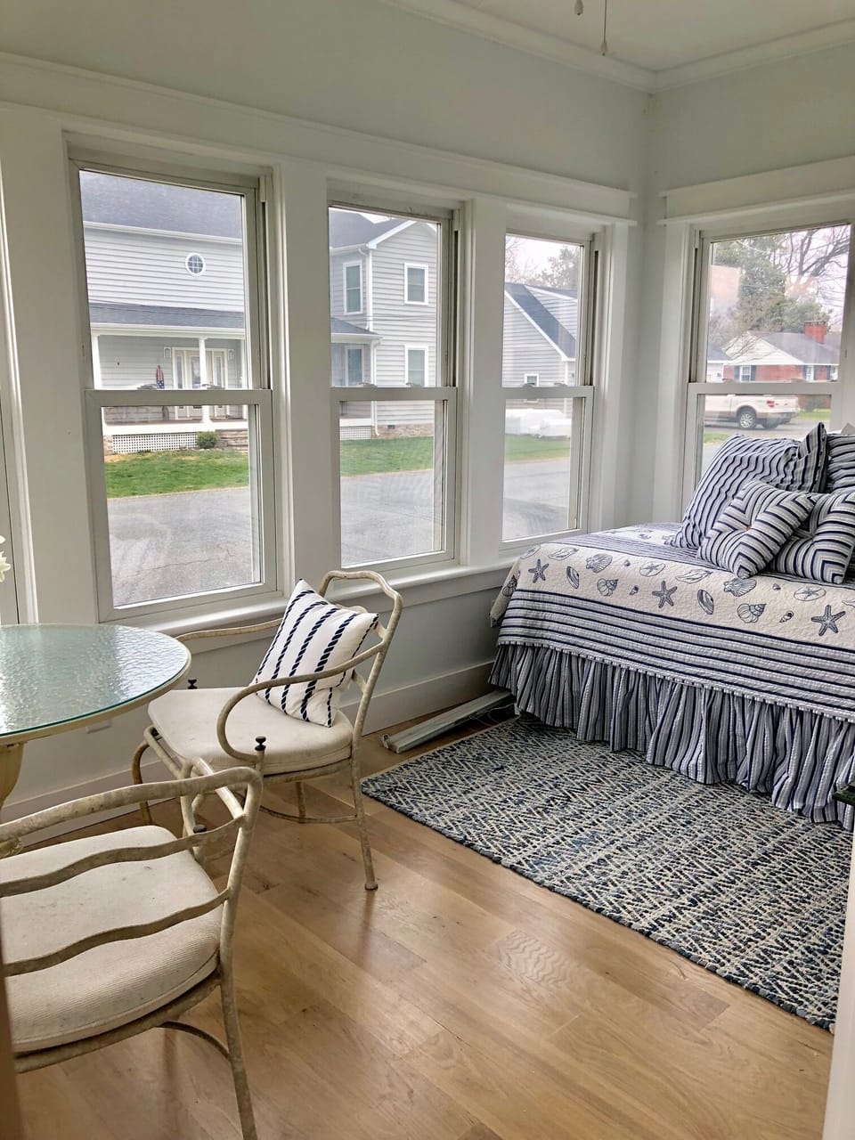 Coastal Sunroom with twin day bed over looks the river