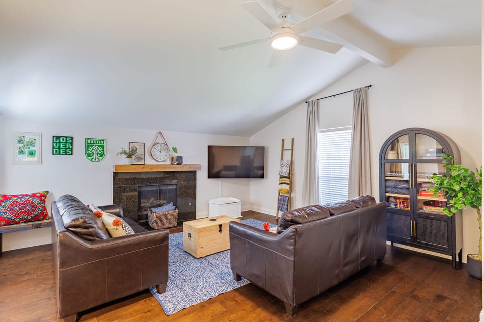 Comfortable living room with 65" Samsung Smart TV, games and books