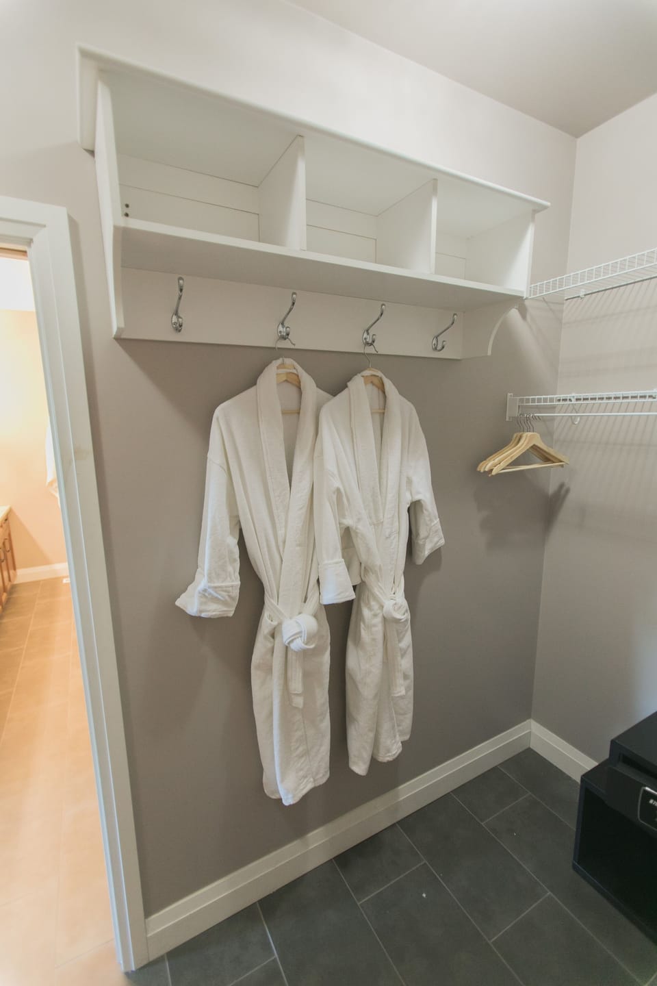 Walk-in closet in master bedroom, with complimentary bath robes